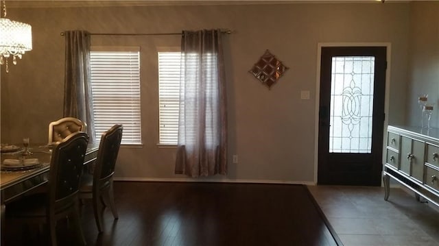 dining area featuring a notable chandelier, plenty of natural light, and dark hardwood / wood-style flooring