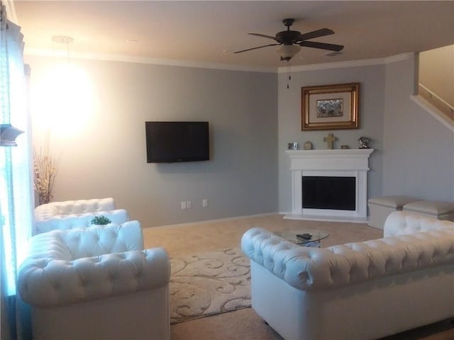 living room featuring carpet, ceiling fan, and crown molding