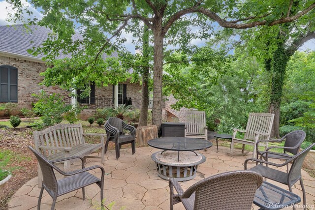 view of patio / terrace featuring an outdoor fire pit