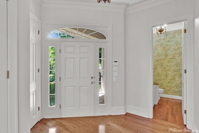 entryway featuring crown molding and light hardwood / wood-style flooring