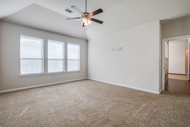 spare room with vaulted ceiling, carpet, and ceiling fan