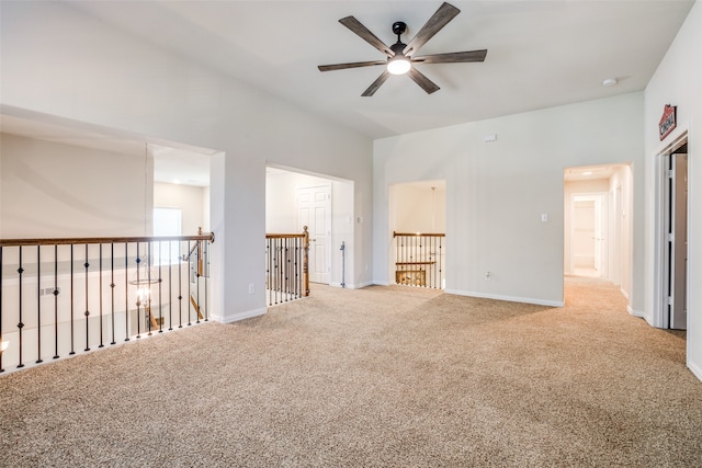 empty room featuring ceiling fan and carpet flooring