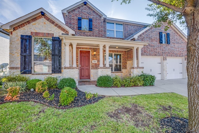 craftsman inspired home featuring a garage and covered porch