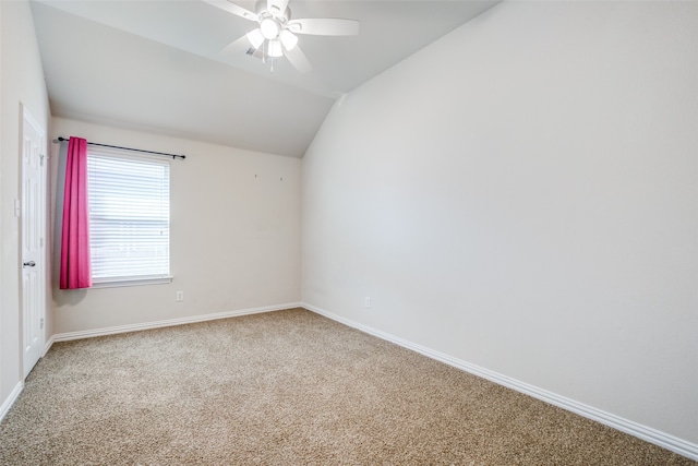 carpeted empty room with ceiling fan and lofted ceiling