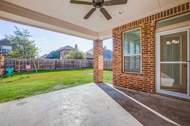 view of patio featuring ceiling fan and a playground