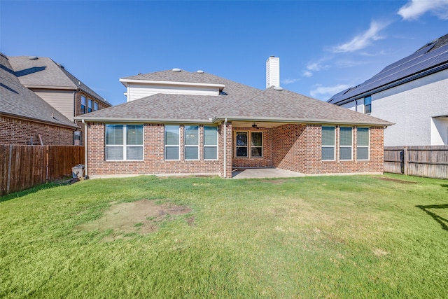 back of property featuring a lawn and a patio