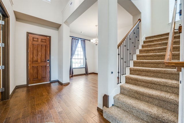 foyer featuring dark hardwood / wood-style floors and an inviting chandelier