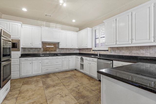 kitchen with ornamental molding, backsplash, stainless steel appliances, and white cabinets