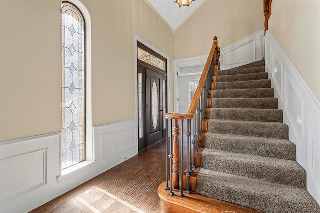 foyer featuring dark hardwood / wood-style flooring and a high ceiling