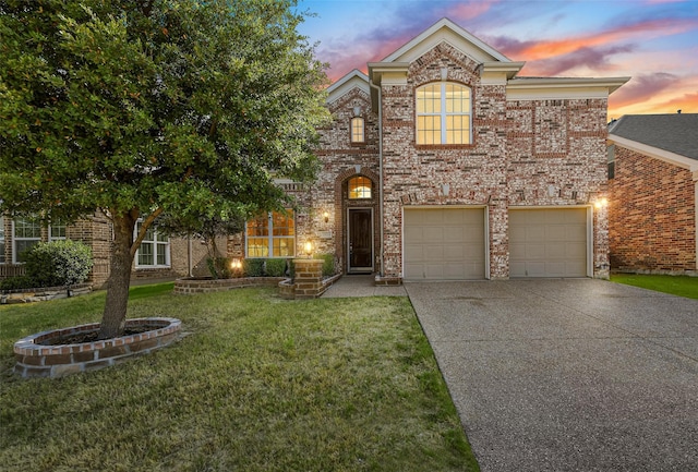 view of front of home with a yard and a garage