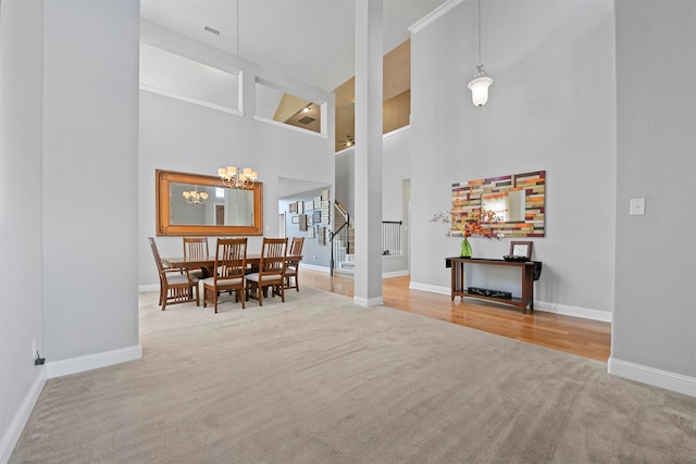 unfurnished living room with ceiling fan, a high ceiling, and light wood-type flooring