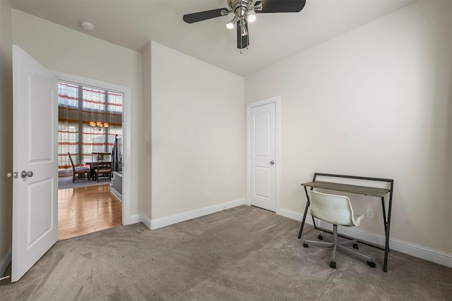 interior space featuring ceiling fan, visible vents, vaulted ceiling, baseboards, and light carpet