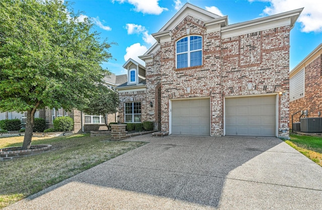 view of front facade featuring central AC, a front yard, and a garage