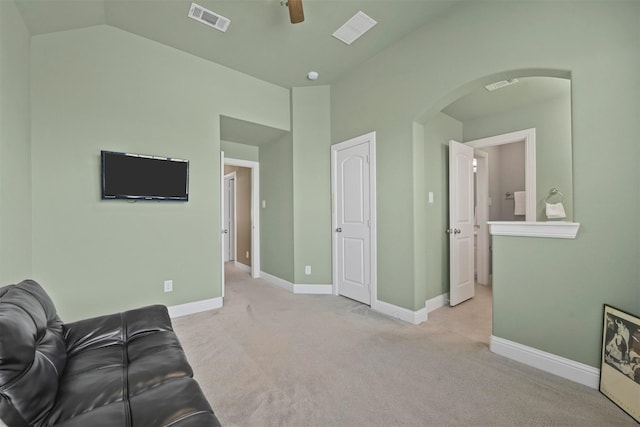 carpeted living room featuring ceiling fan and vaulted ceiling