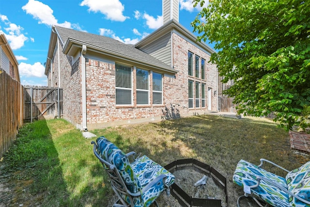 rear view of house featuring a yard