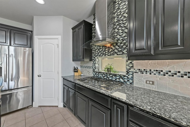 kitchen with a high ceiling, a sink, light wood-style floors, dark cabinets, and a kitchen bar