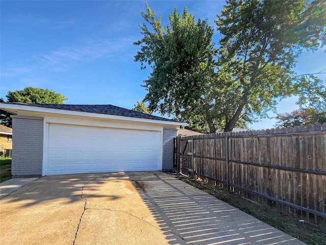 detached garage featuring fence