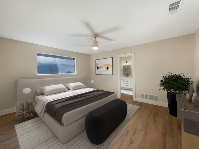 bedroom featuring light wood-style floors, visible vents, and baseboards