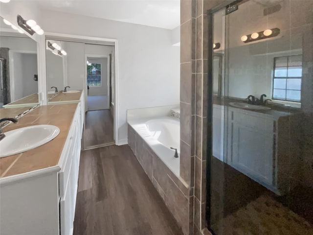 bathroom with double vanity, a sink, and a shower stall