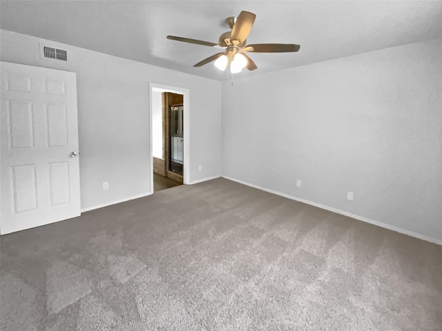 unfurnished bedroom featuring carpet floors, visible vents, connected bathroom, ceiling fan, and baseboards