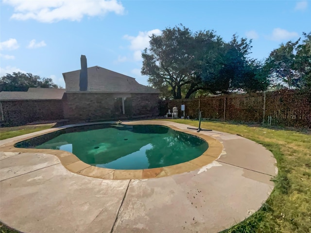 view of swimming pool featuring a patio area, a fenced backyard, a fenced in pool, and a yard