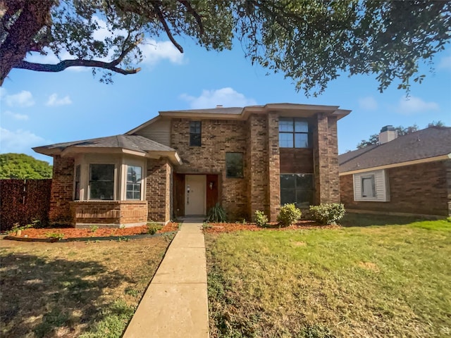 view of front of home featuring a front yard and brick siding