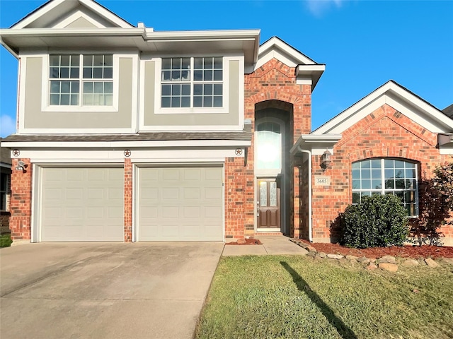 view of front of house featuring a front yard, brick siding, driveway, and an attached garage