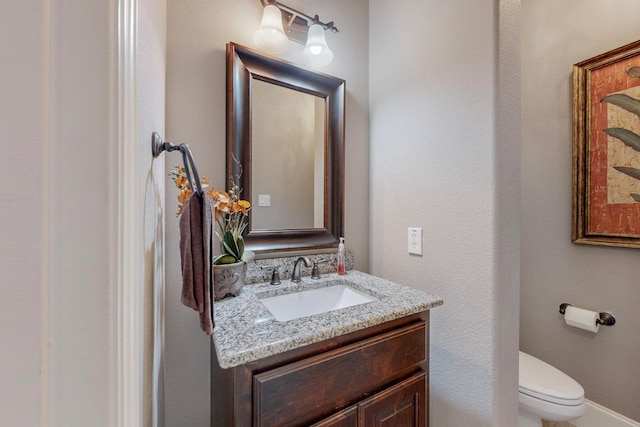 bathroom featuring toilet and vanity