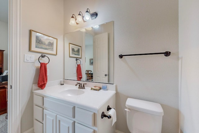 bathroom featuring toilet and vanity