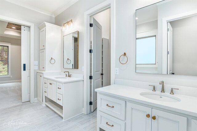 bathroom with tile patterned flooring, vanity, and ornamental molding