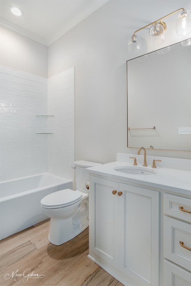 bathroom featuring ornamental molding, vanity, toilet, and wood finished floors