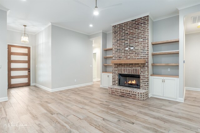 unfurnished living room with light wood-style floors, a fireplace, baseboards, and built in features