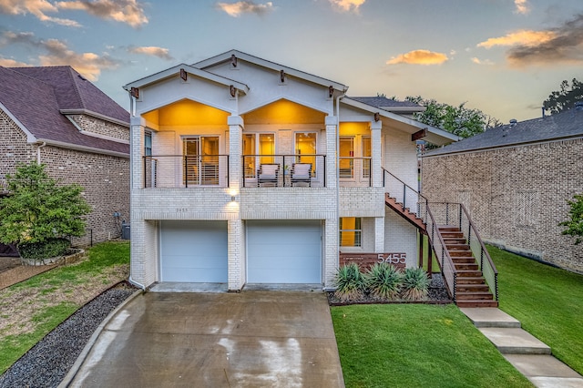 view of front of property with a garage and a lawn