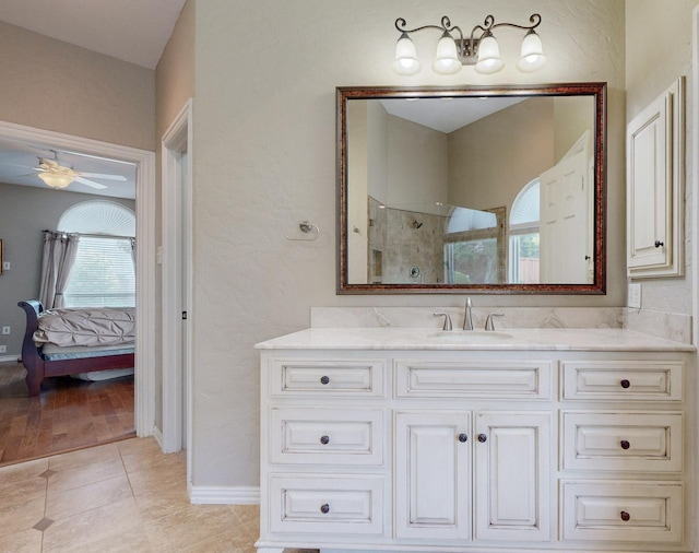 2713 Redfield Dr, Plano, TX 75025 - ensuite bathroom featuring ceiling fan, a walk in shower, vanity, tile patterned flooring, and baseboards