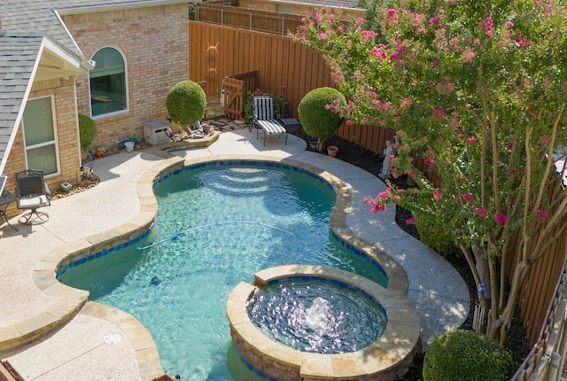 view of pool featuring an in ground hot tub and a patio area