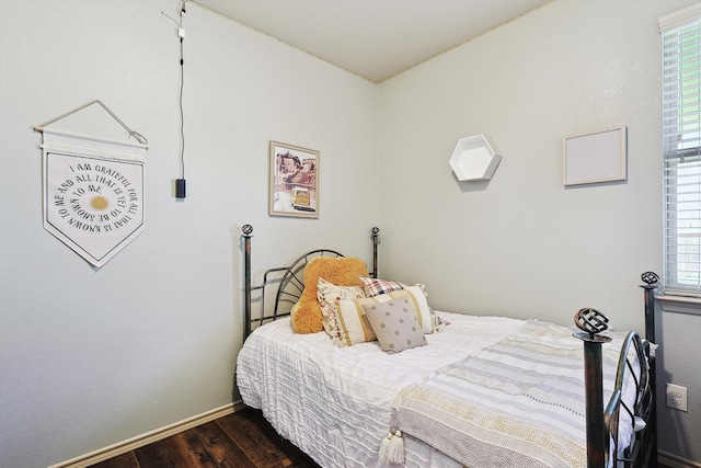 bedroom with dark hardwood / wood-style flooring