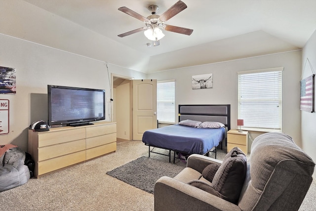 carpeted bedroom with vaulted ceiling and ceiling fan