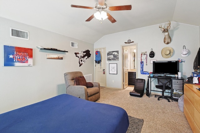 carpeted bedroom with vaulted ceiling, ceiling fan, and ensuite bath