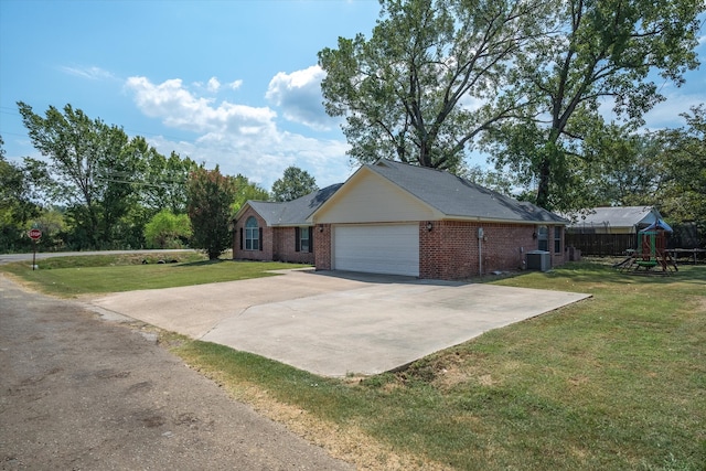 view of home's exterior with central air condition unit, a lawn, a garage, and a playground