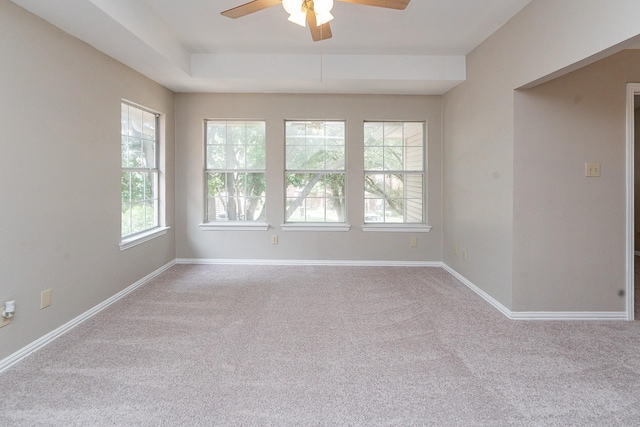 unfurnished room featuring ceiling fan and light carpet