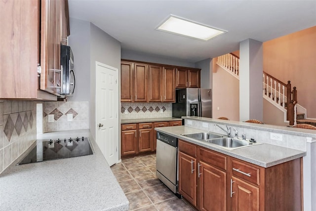 kitchen with black appliances, sink, decorative backsplash, and light tile patterned flooring