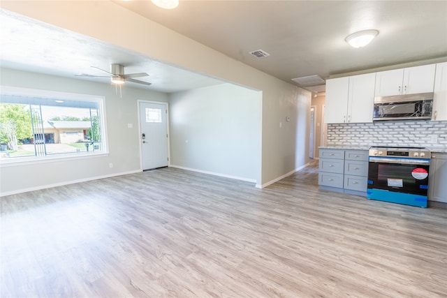 kitchen featuring white cabinets, gray cabinetry, stainless steel appliances, decorative backsplash, and ceiling fan