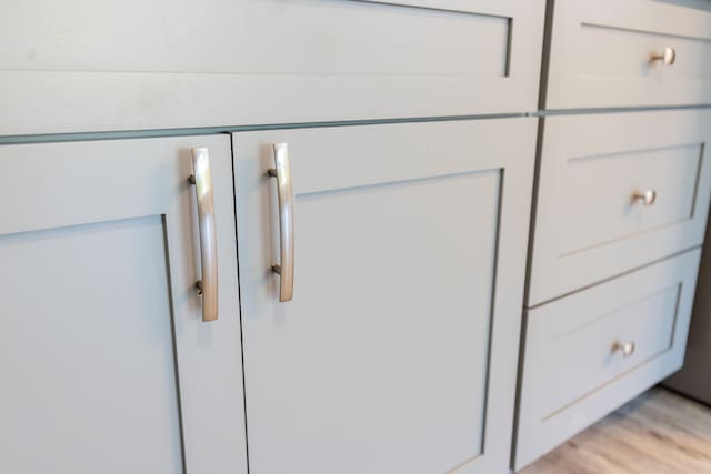 room details featuring light hardwood / wood-style flooring and white cabinets