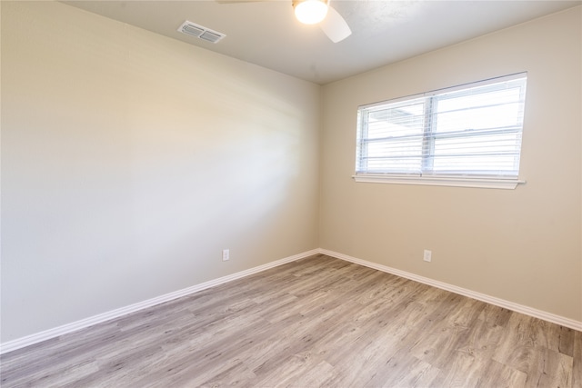 spare room featuring light wood-type flooring and ceiling fan