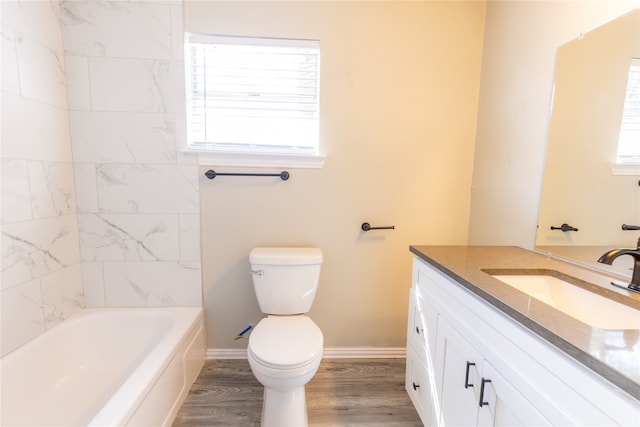 bathroom featuring hardwood / wood-style floors, plenty of natural light, vanity, and toilet