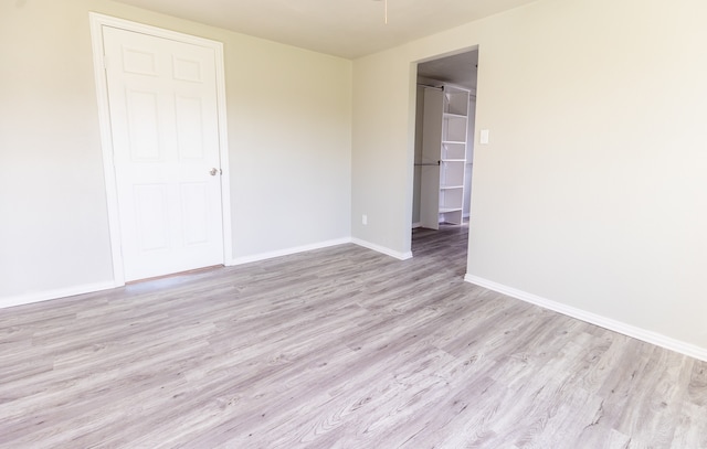 unfurnished room with light hardwood / wood-style floors