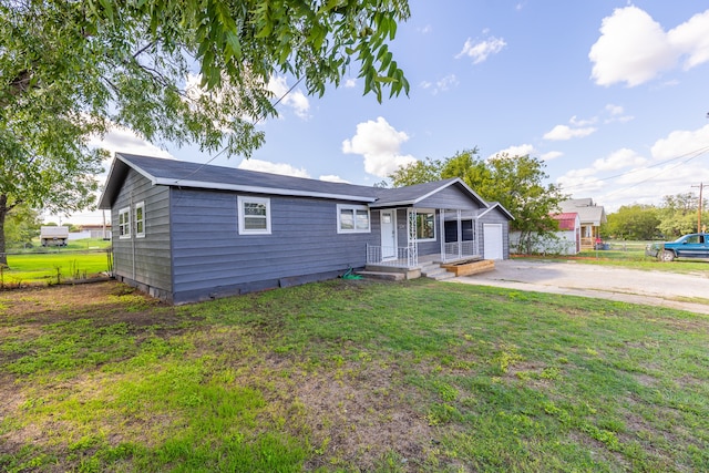 ranch-style house with a front yard and a garage