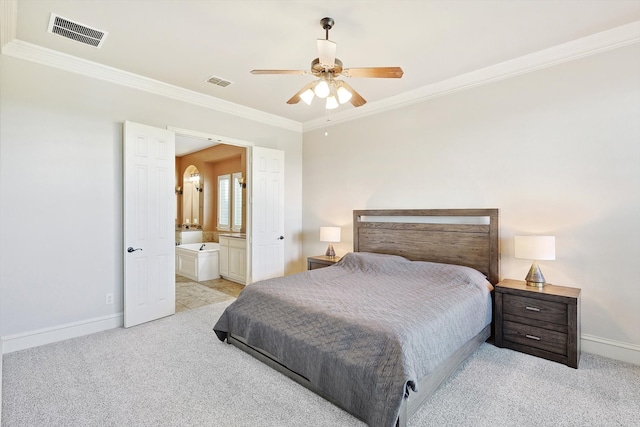 carpeted bedroom with ceiling fan, ornamental molding, and ensuite bathroom