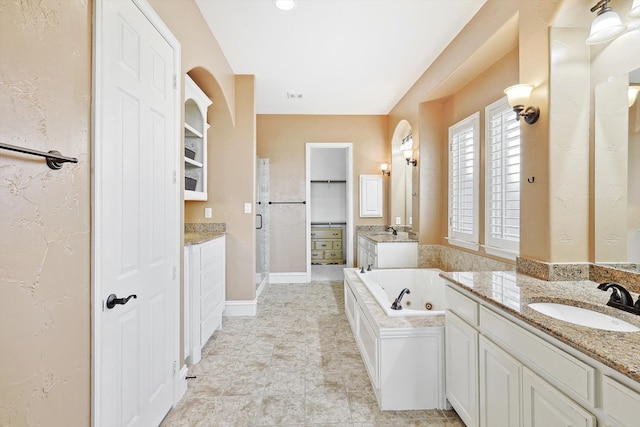 bathroom with tile patterned flooring, vanity, and separate shower and tub