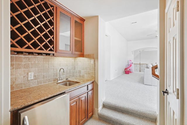 kitchen with dishwasher, tasteful backsplash, and sink